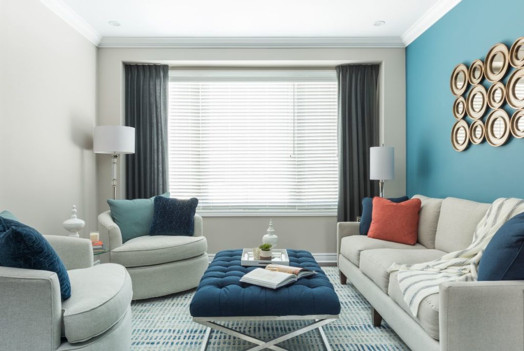 Scale your home design back on neutral colors like this sea blue accent wall and pillows