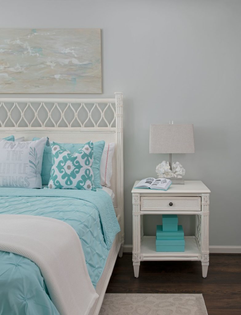 How to hang wall art above a bed with a headboard
